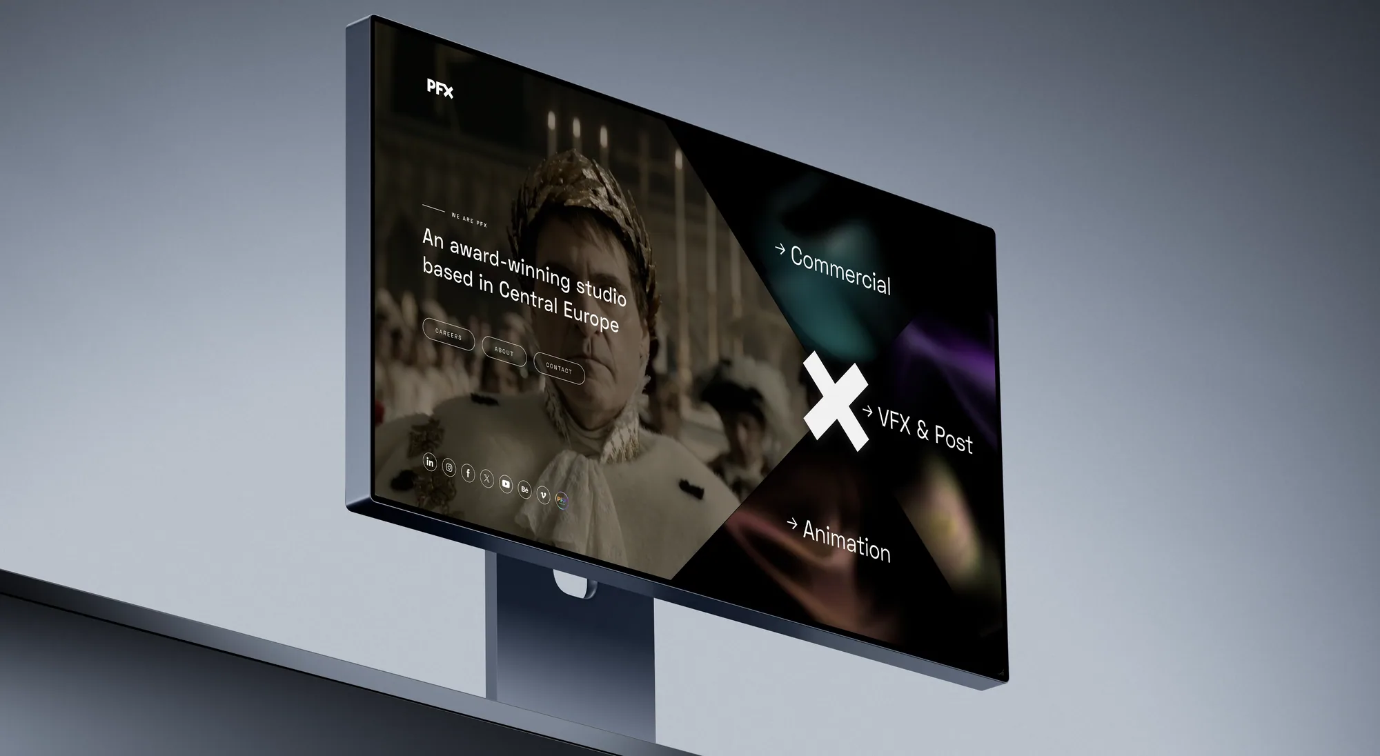 Nakloněný monitor s úvodní stránkou PFX: filmový záběr s kostýmovanou postavou za nápisem „An award-winning studio based in Central Europe“ a šikmé panely Commercial, VFX & Post a Animation.
